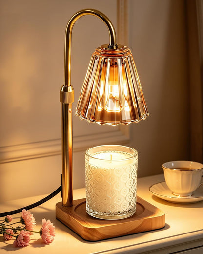 Gold candle warmer lamp glowing on a bedside table